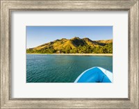Blue boat cruising through the Yasawa, Fiji, South Pacific Fine Art Print