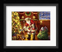 Santa putting gifts under tree Fine Art Print