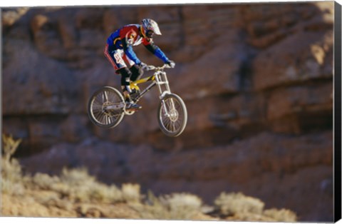 Framed Side profile of a person on a bicycle in mid air Print