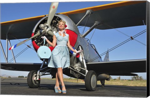 Framed Elegant 1940's style pin-up girl standing in front of an F3F biplane Print