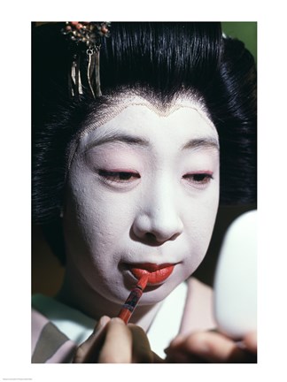 Framed Close-up of a geisha applying lipstick to her lips Print