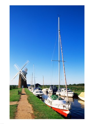 Framed Boats moored near a traditional windmill, Horsey Windpump, Horsey, Norfolk Broads, Norfolk, England Print