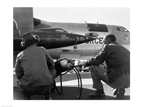 Framed Rear view of two men crouching near fighter planes, X-15 Rocket Research Airplane, B-52 Mothership Print