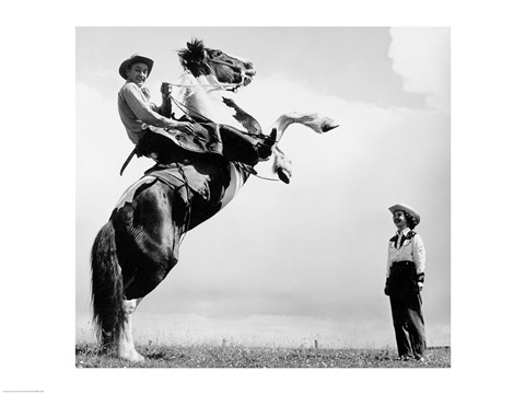 Framed Low angle view of a cowboy riding a bucking horse Print