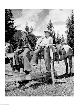 Framed Teenage cowboys sitting on rail fence Print