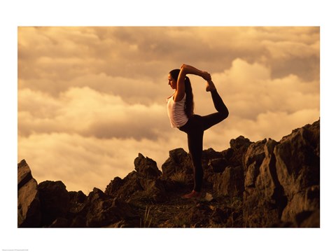 Framed Silhouette of a young woman Practicing Yoga on Mountainside Print