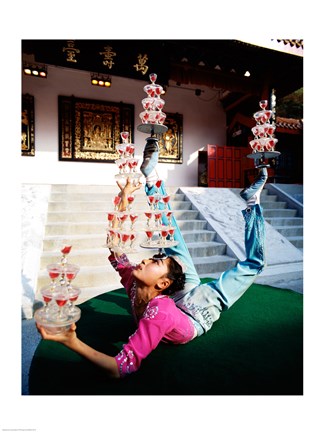 Framed Acrobat balancing glasses, Shanghai, China Print