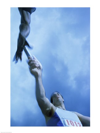 Framed Low angle view of runners passing a baton in a relay race Print