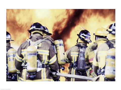 Framed Rear view of a group of firefighters holding water hoses Print