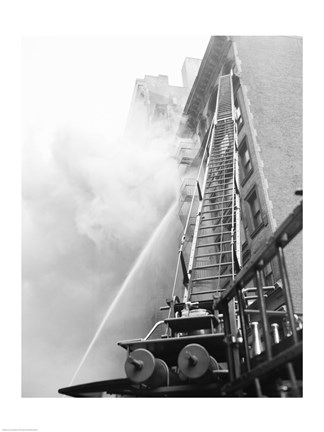 Framed Fire engine with ladder up burning building Print