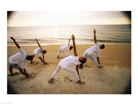 Framed Group of people performing yoga on the beach Print