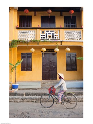 Framed Person riding a bicycle in front of a cafe, Hoi An, Vietnam Print