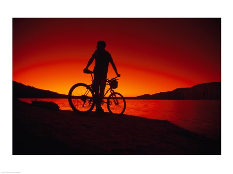 Framed Silhouette of a man standing with a bike, Lake Powell, Utah Print