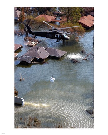 Framed Blackhawk helicopter drops sandbags into an area where the levee broke due to Hurricane Katrina Print