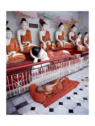 Framed Monk Sleeping in Front of Buddha Statues Print