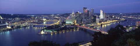 Framed Buildings along a river lit up at dusk, Monongahela River, Pittsburgh, Allegheny County, Pennsylvania, USA Print