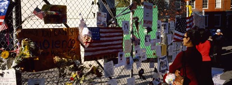 Framed Side profile of a woman standing in front of chain-link fence at a memorial, New York City, New York State, USA Print