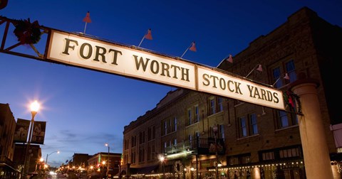 Framed Signboard over a road at dusk, Fort Worth Stockyards, Fort Worth, Texas, USA Print