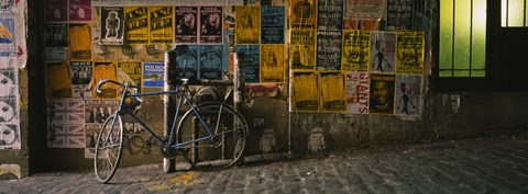 Framed Bicycle leaning against a wall with posters in an alley, Post Alley, Seattle, Washington State, USA Print