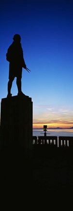 Framed Captain Cook monument silhouetted by sunset, Anchorage, Alaska, USA. Print