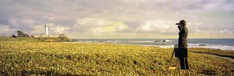 Framed USA, California, Businessman standing holding binoculars and looking at the lighthouse Print