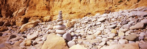 Framed Stack of stones on the beach, California, USA Print