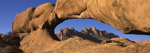 Framed Mountains viewed through a natural arch with a mother holding her baby, Spitzkoppe, Namib Desert, Namibia Print