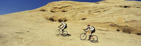 Framed Side profile of two men mountain bilking on rocks, Slickrock Trail, Moab, Utah, USA Print