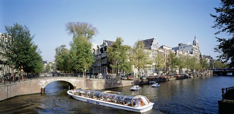Framed Netherlands, Amsterdam, tour boat in channel Print