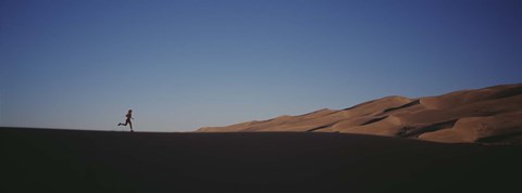 Framed USA, Colorado, Great Sand Dunes National Monument, Runner jogging in the park Print