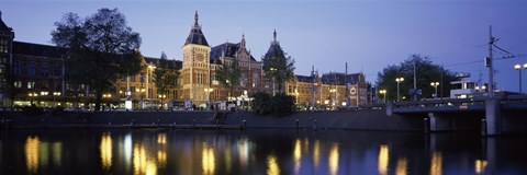 Framed Reflection of a railway station in water, Amsterdam Central Station, Amsterdam, Netherlands Print
