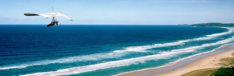 Framed Hang glider over the sea Print