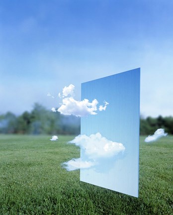 Framed White clouds passing through a pale blue horizontal of sky with green grass, trees and sky in the distance Print