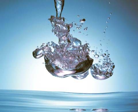 Framed Iridescent water bubble formation floating above the surface of deep blue water Print