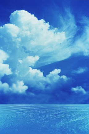 Framed White clouds in dark blue sky over rippling water Print