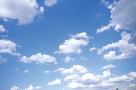 Framed Cumulus Clouds Against a Bright Blue Sky Print