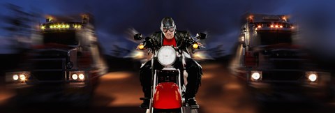 Framed Motorcycle rider between two semi trucks Print