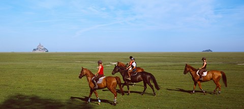 Framed Horseback riders in a field with Mont Saint-Michel island in background, Manche, Basse-Normandy, France Print