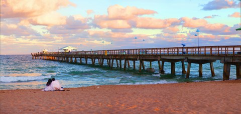Framed Couple sitting on the beach at sunset, Fort Lauderdale, Florida, USA Print