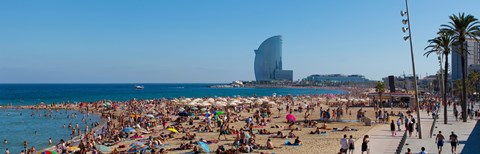Framed Tourists on the beach with W Barcelona hotel in the background, Barceloneta Beach, Barcelona, Catalonia, Spain Print