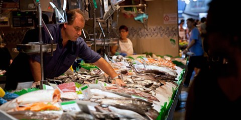 Framed Fishmonger at a fish stall, La Boqueria Market, Ciutat Vella, Barcelona, Catalonia, Spain Print