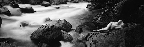 Framed Side profile of a naked woman lying on a rock Print