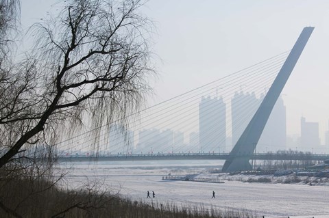 Framed Songhuajiang Highway Bridge over the frozen Songhua River with buildings in the background, Harbin, Heilungkiang Province, China Print