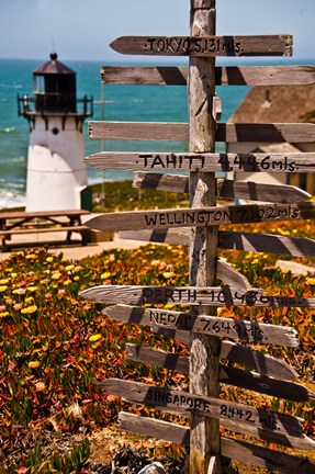 Framed Directional signs on a pole with light house in the background, Point Montara Lighthouse, Montara, California, USA Print