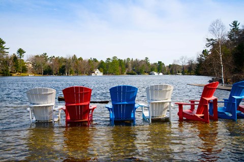 Framed Adirondack chairs partially submerged in the Lake Muskoka, Ontario, Canada Print