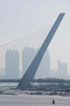 Framed Songhuajiang Highway Bridge across the frozen Songhua River with buildings in the background, Harbin, China Print