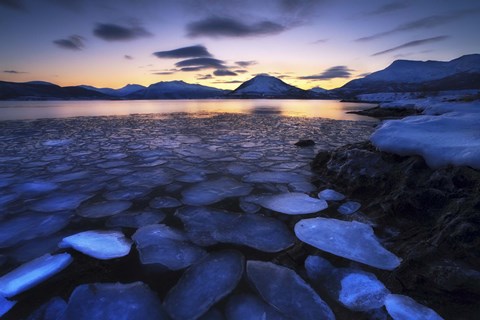 Framed Ice flakes drifting against the sunset in Tjeldsundet strait, Troms County, Norway Print