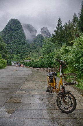 Framed Bicycle sits in front of the Guilin Mountains, Guilin, Yangshuo, China Print