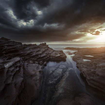 Framed Huge rocks on the shore of a sea against stormy clouds, Sardinia, Italy Print