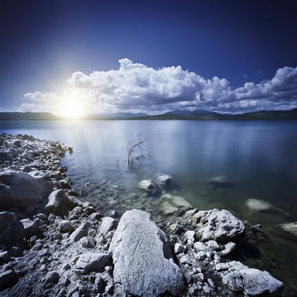 Framed Tranquil lake and rocky shore with sun over horizon, Sardinia, Italy Print